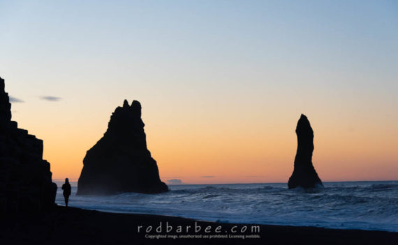 Seastacks and visitor at the seastacks near Vik, Iceland.